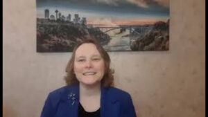 Picture of Lori Lococo with a Niagara Falls picture behind her