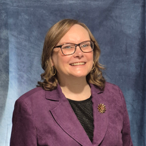 Lori Lococo Smiling in a Purple Jacket