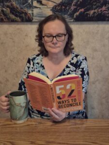 Lori reading 52 to Ways to Reconcile book